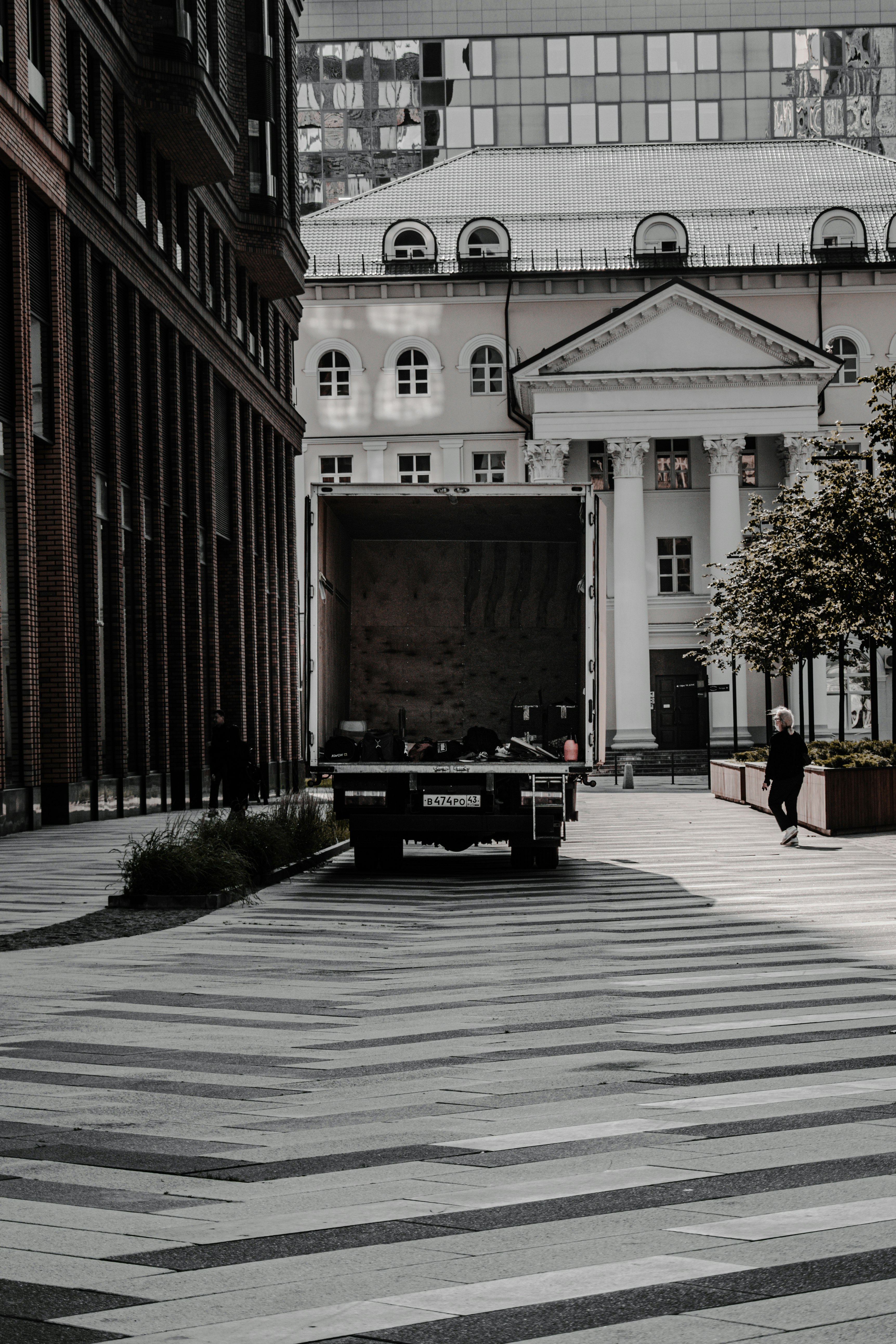 black car parked near brown building during daytime